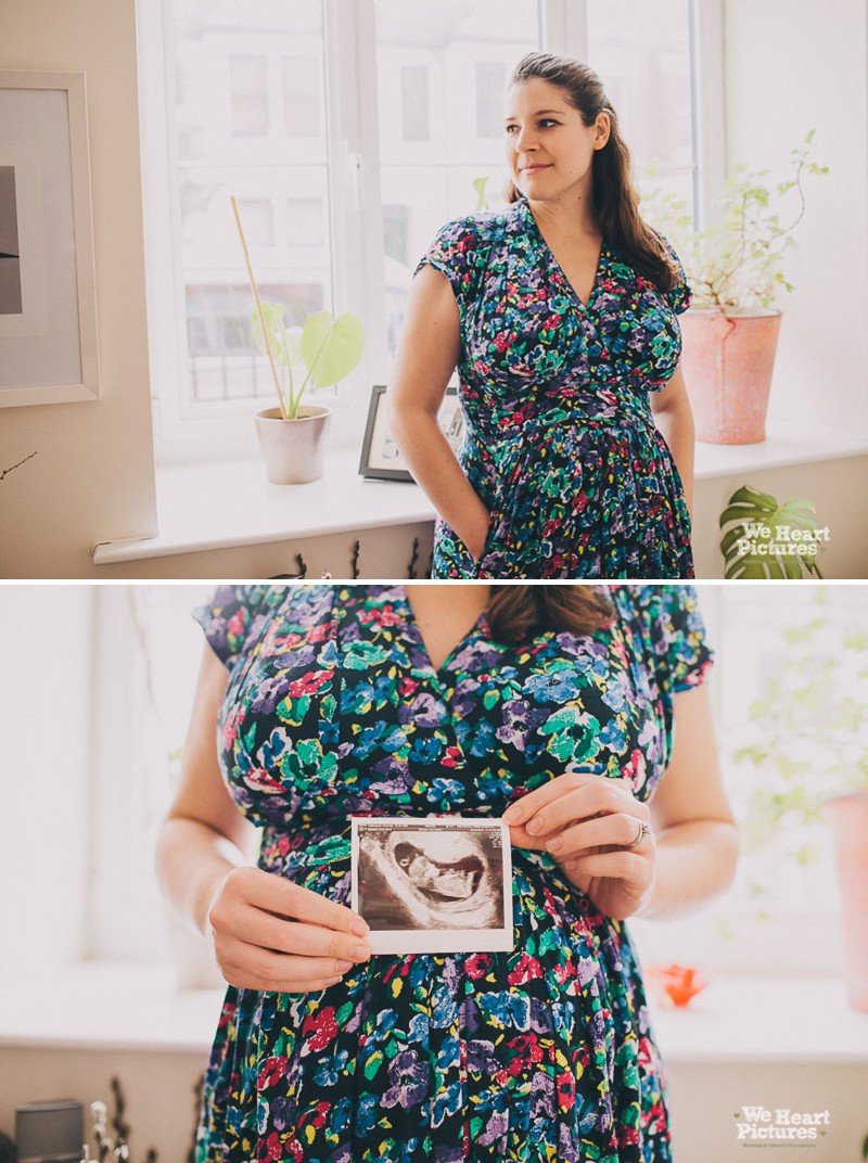 Mum at home holding a scan of her baby.