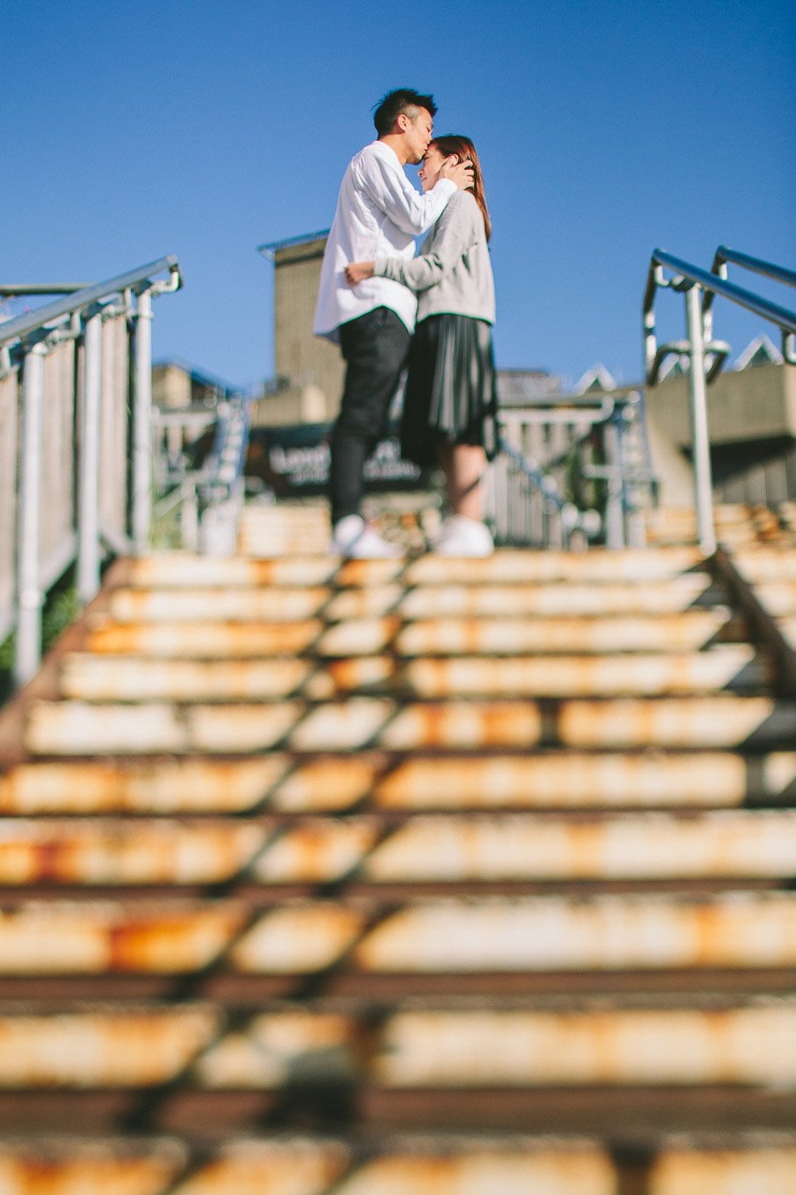 Portrait of a couple hugging a t the top of stairs, Alternative wedding photographer in London