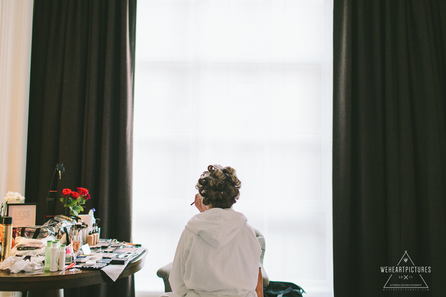 Bride with hair rolls Getting ready at a winter wedding.