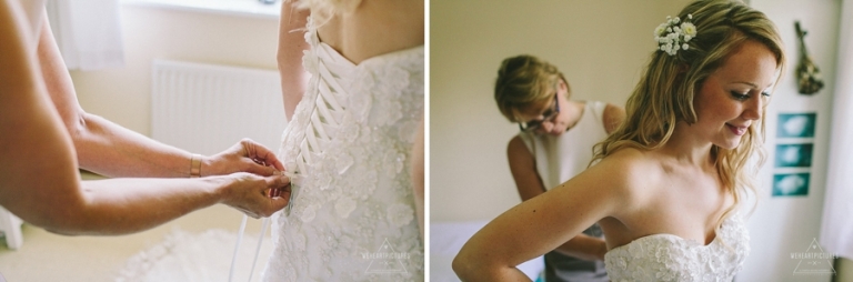 Mother helping daughter to put wedding dress on | Creative Wedding Photography UK & Destination >> weheartpictures.com