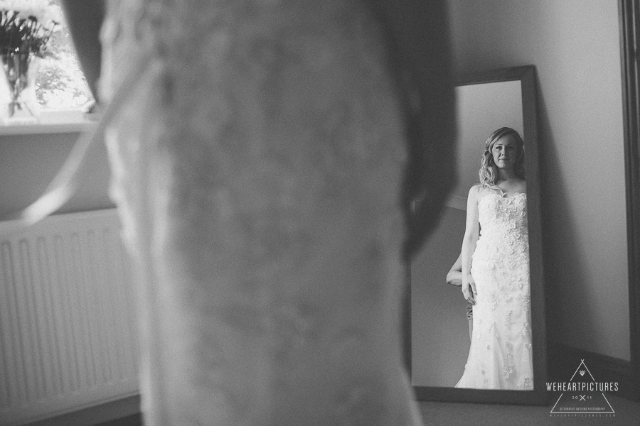 Bride admiring her wedding dress | London Alternative Wedding Photography UK & Destination srcset=