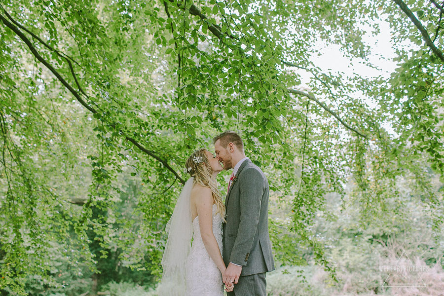 Bride and Groom kissing under a tree | Creative Wedding Photography UK & Destination >> weheartpictures.com