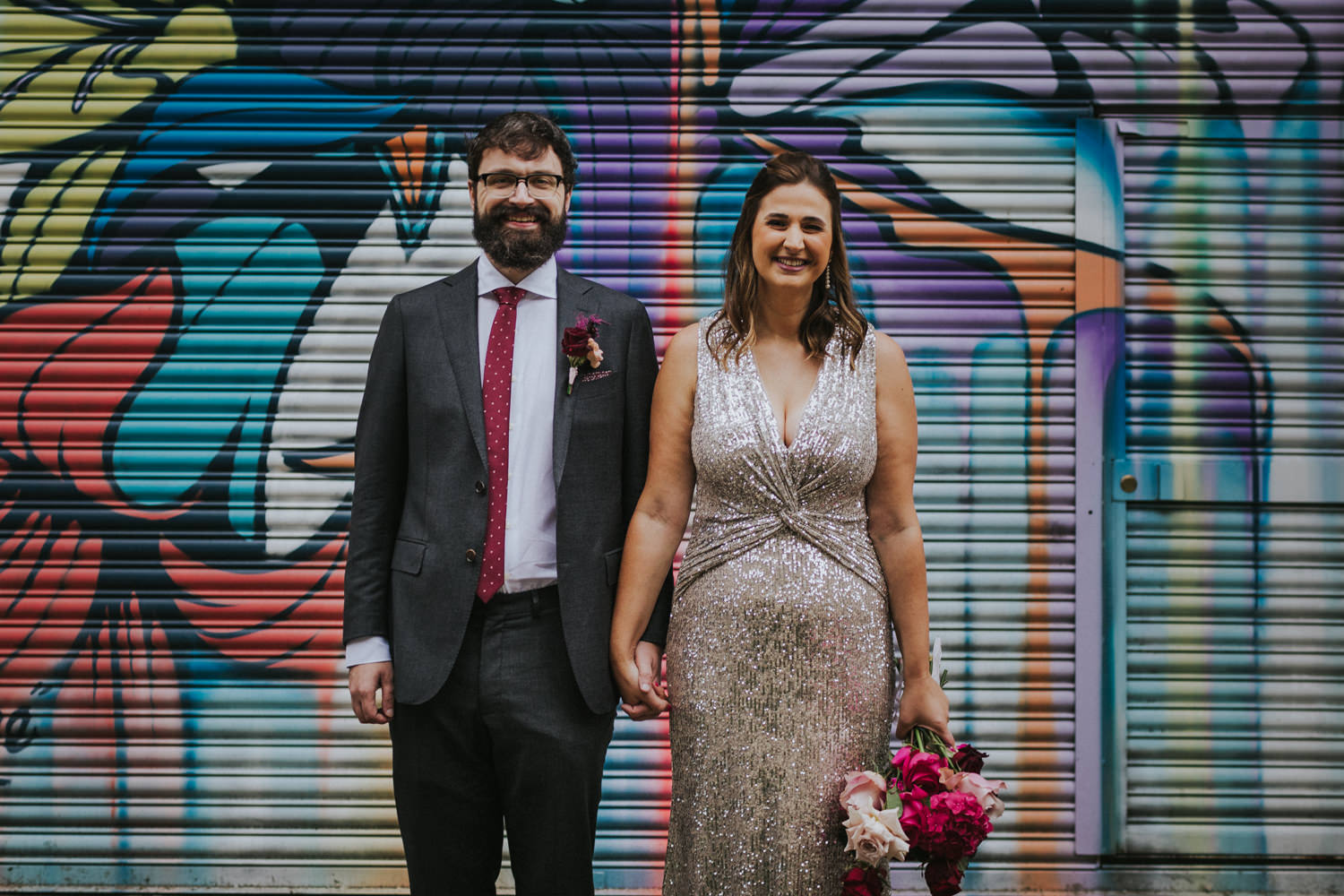 Bride and Groom in the streets of east London in front of street art.