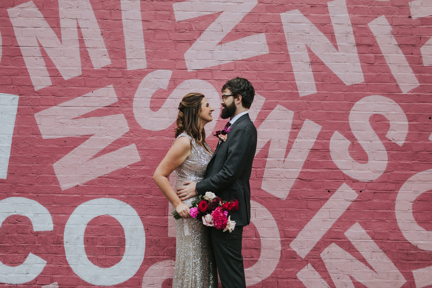 Bride and groom in front of a pink wall. London Hackney Coffee Co Wedding Photographer.