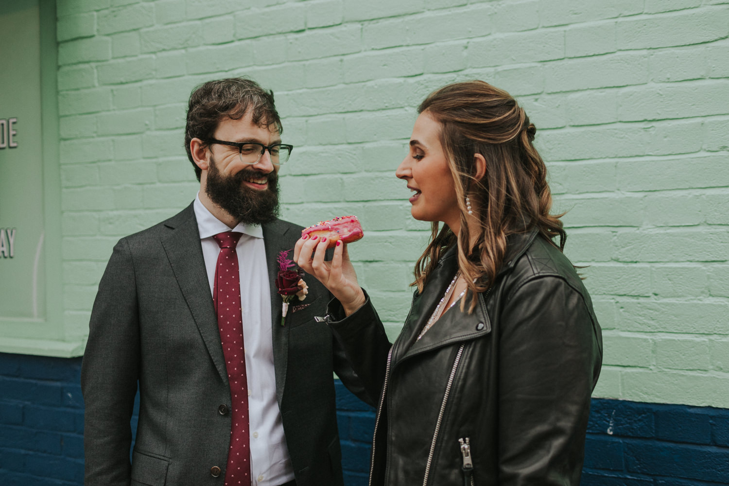 Bride and Groom eating a doughnut in East London. 