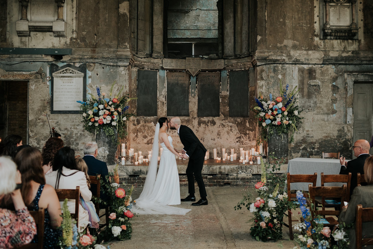 Bride and groom first kiss - London Wedding Ceremony at Asylum Chapel in Caroline Gardens - Alternative Wedding Photography We Heart Pictures 