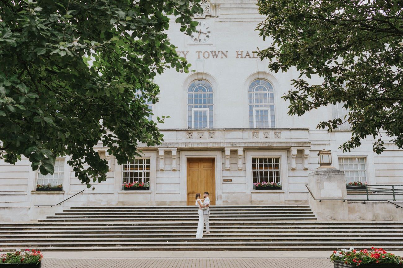 Bride and groom in front of Hackney Town Hall