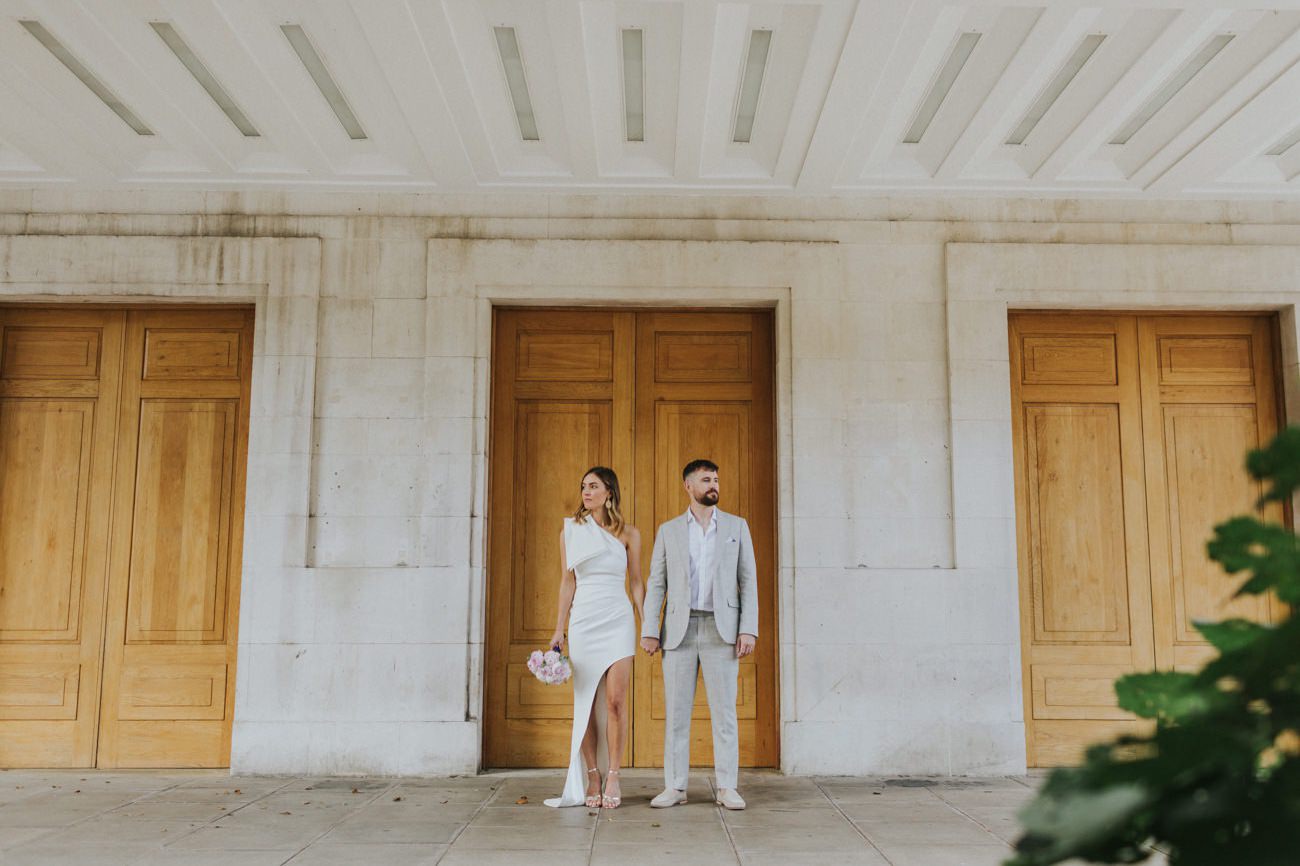 Bride and groom's portraits in front of Hackney Town Hall London after their Elopement ceremony. 