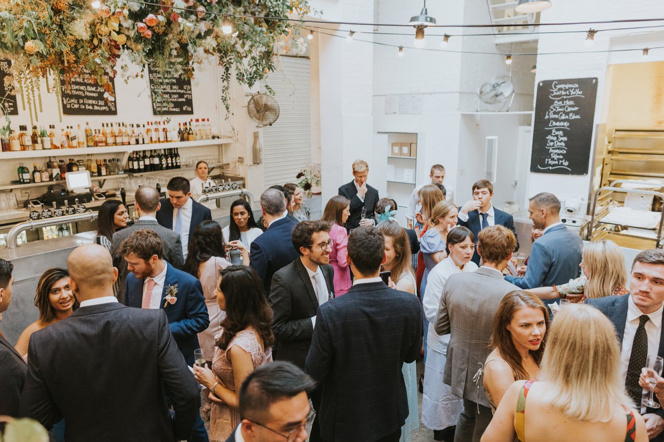 white space wedding venue filled with guests