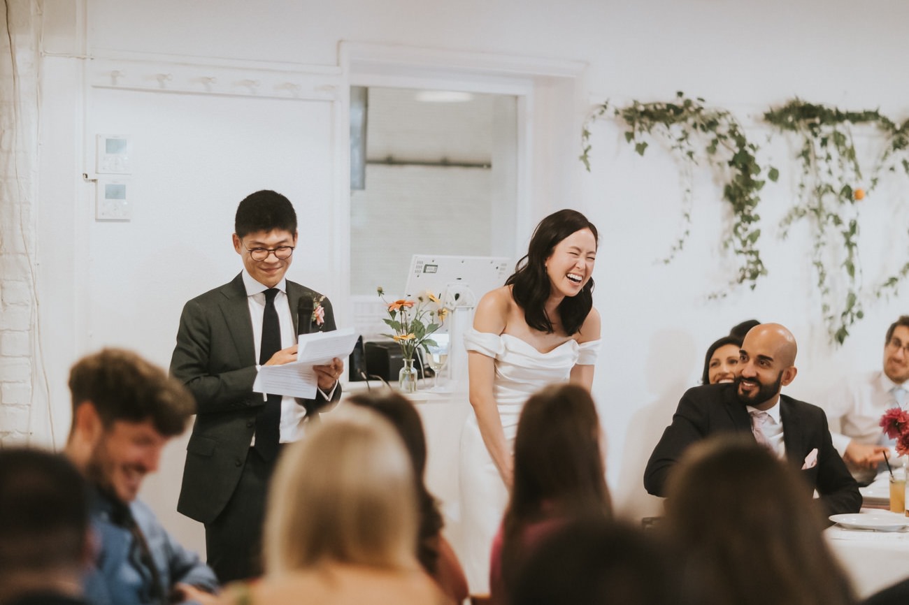 Happy couple give speech at wedding